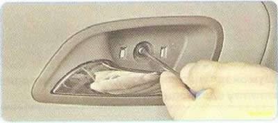 4. Под накладкой выверните винт крепле­ния обивки…