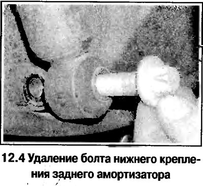 4. Отверните нижний болт крепления амортизатора…