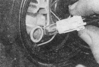 Рис. 8.21. Выньте патрон из фары — отсоединять…
